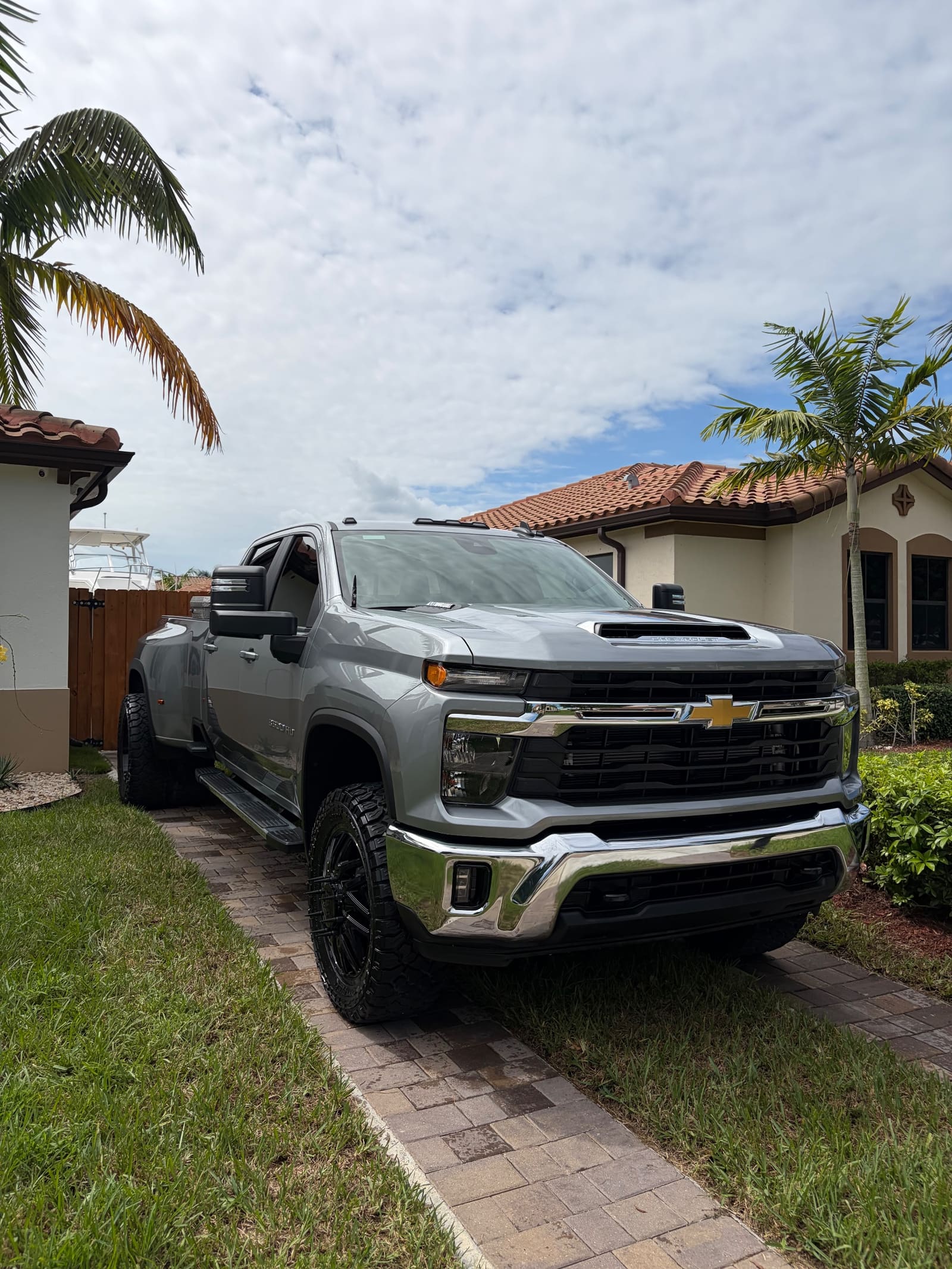 Silver Chevrolet Silverado dually, washed and finished on a Florida driveway