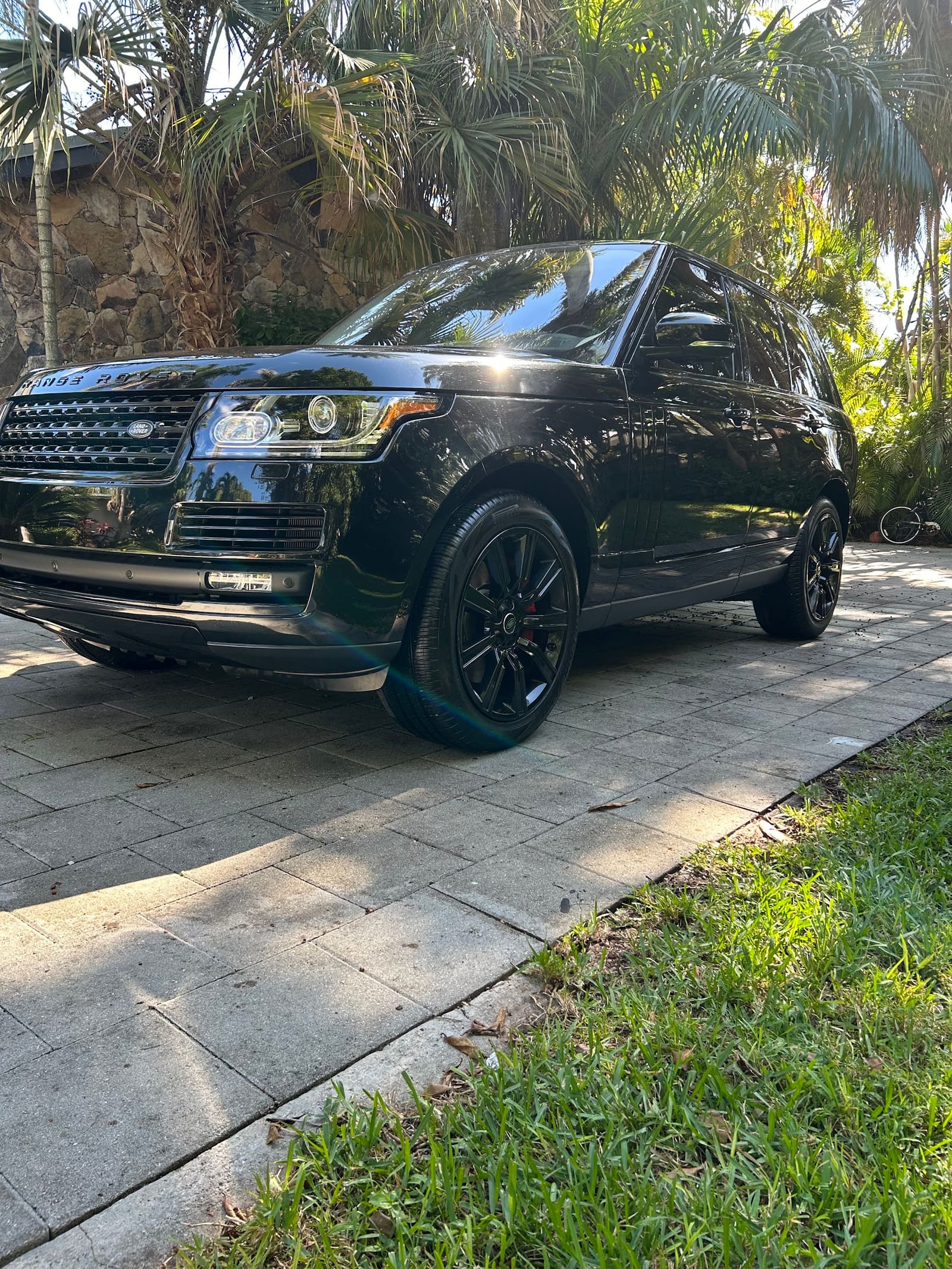 Black Range Rover detailed on a paver driveway