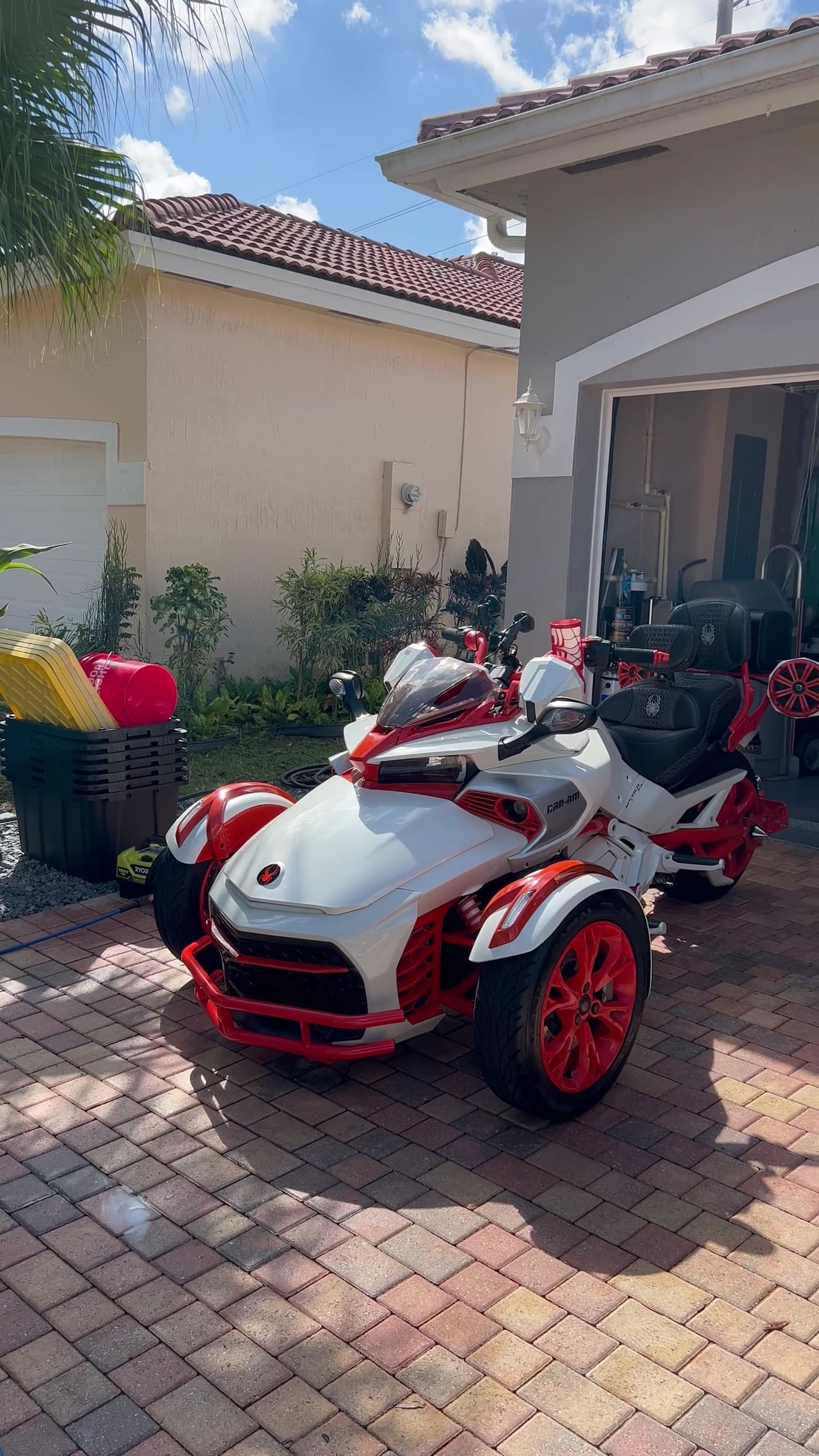 Can-Am Spyder three-wheeler cleaned on a paver driveway
